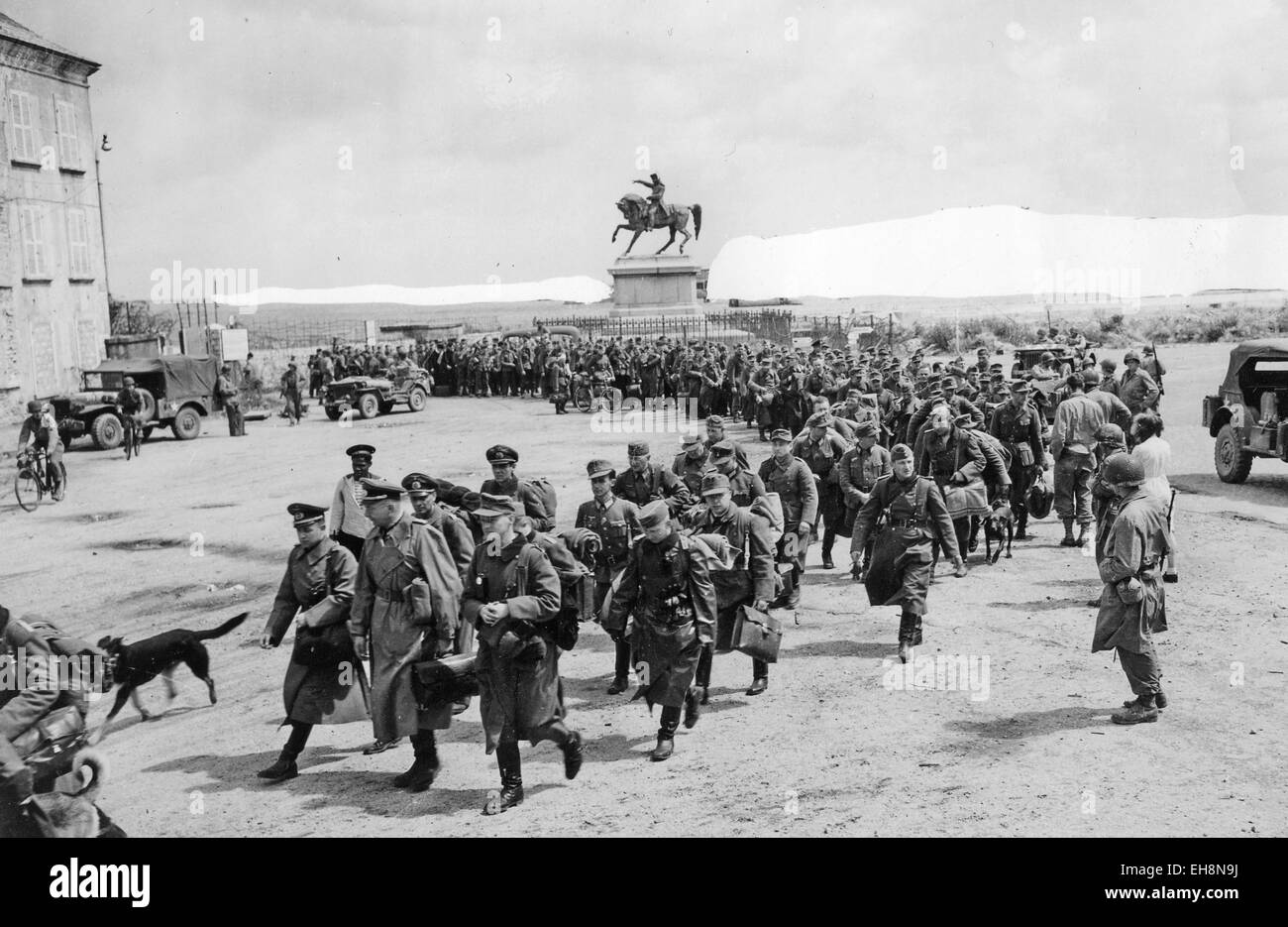 BATTLE OF CHERBOURG German prisoners are marched away watched by US