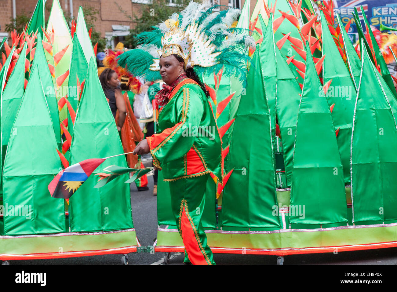 Side view of woman wearing carnival costume of green satin matching the