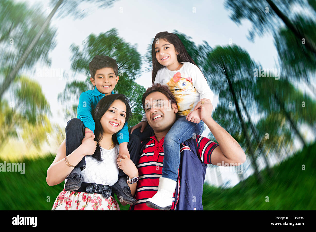 4 indian Parents and kids park enjoy Stock Photo