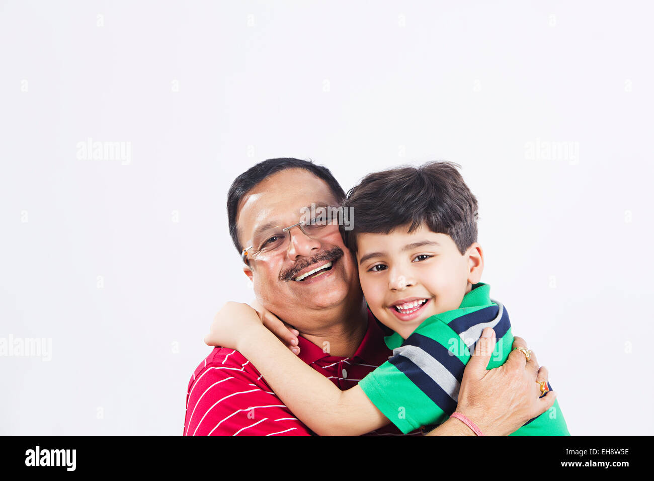 2 indian grand father and Grand son Hugging Stock Photo