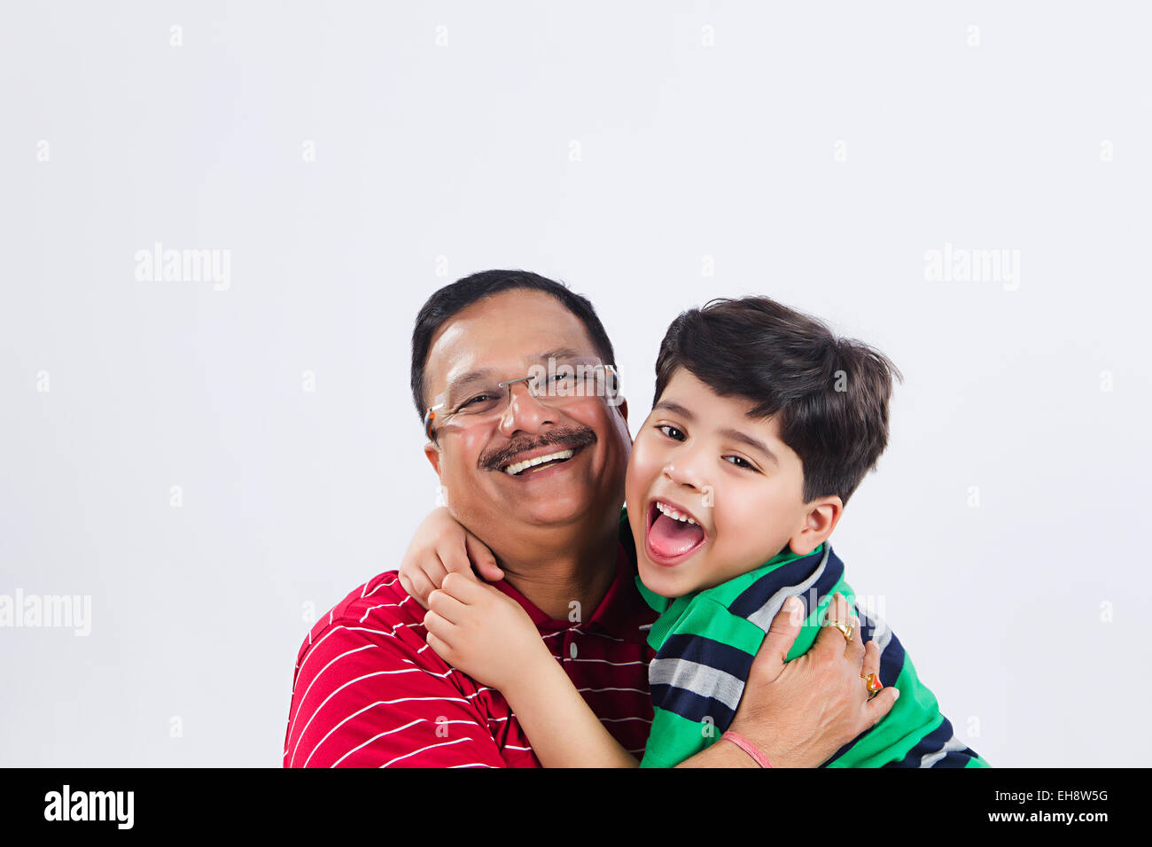 2 indian grand father and Grand son Hugging Stock Photo
