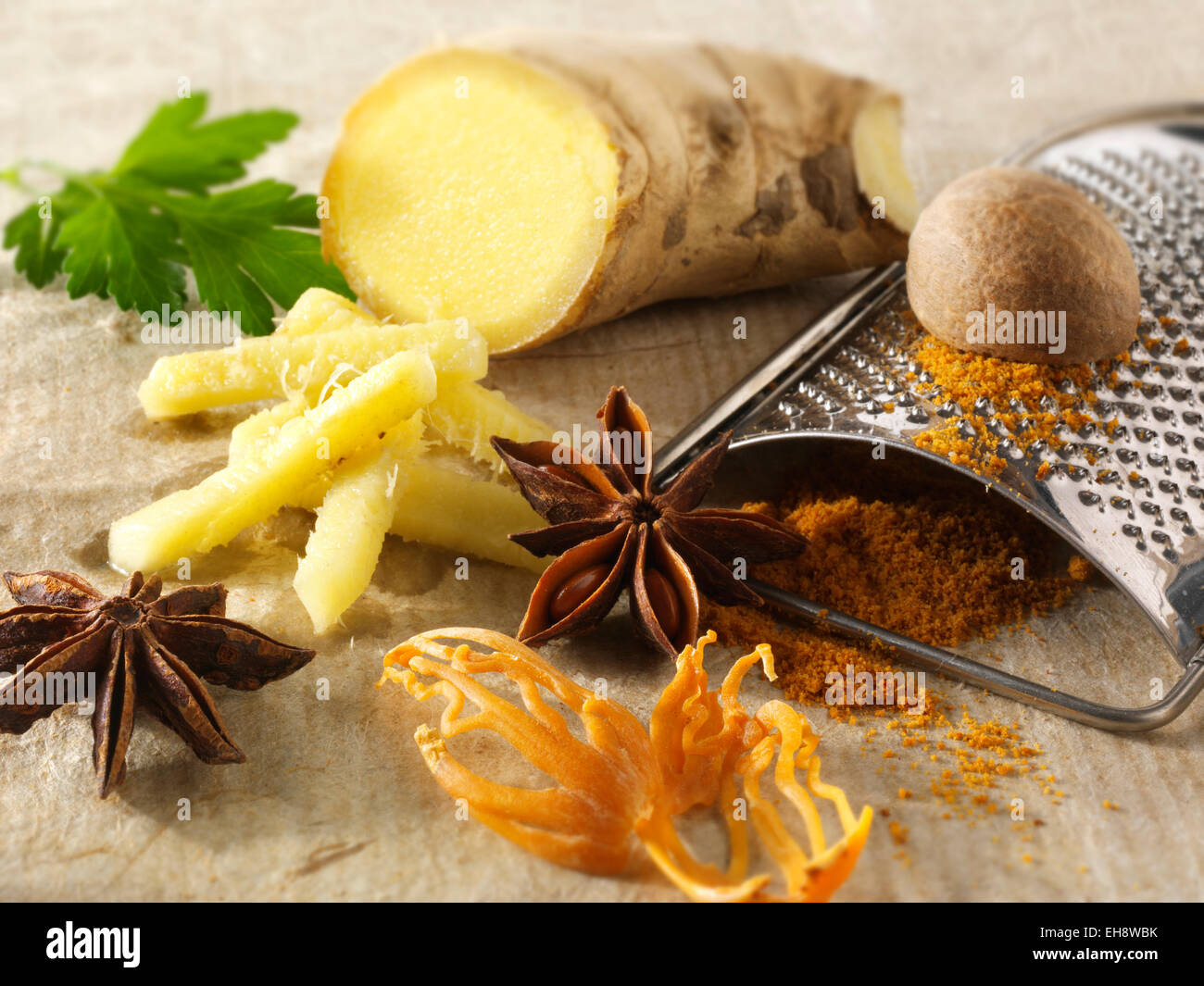 Fresh ginger root, star anise, nutmeg & mace. Indian spices composed arrangement Stock Photo