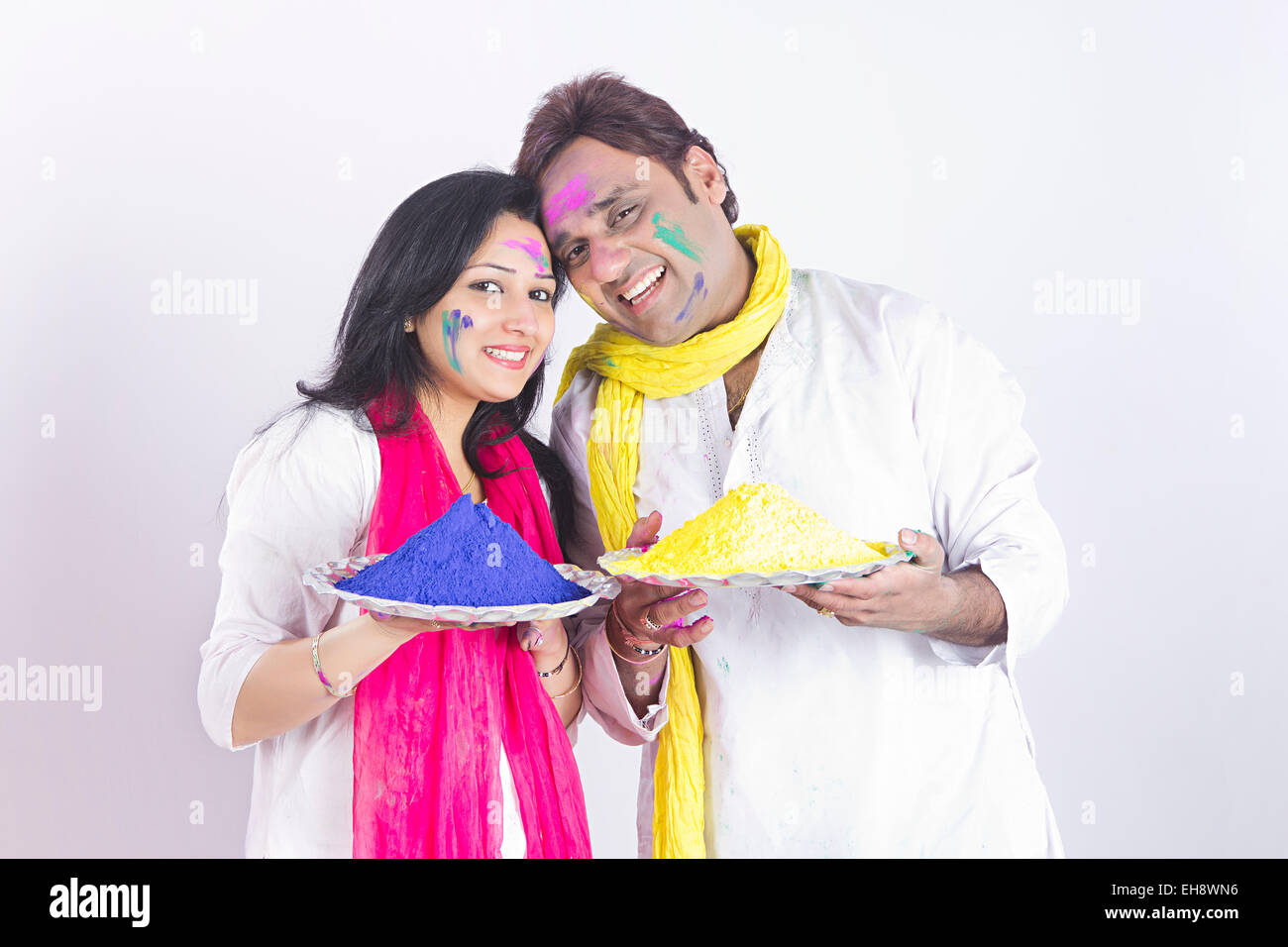 2 indian Married couples holi Festival Plate Colour holding Welcome Stock Photo