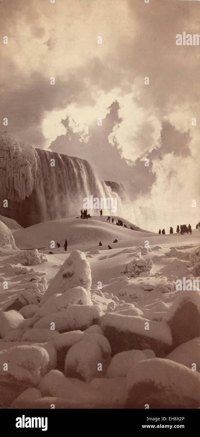 Visitors walk on snow covered ice at the base of the American Falls at Niagara Falls c. 1883. (Library of Congress) Stock Photo