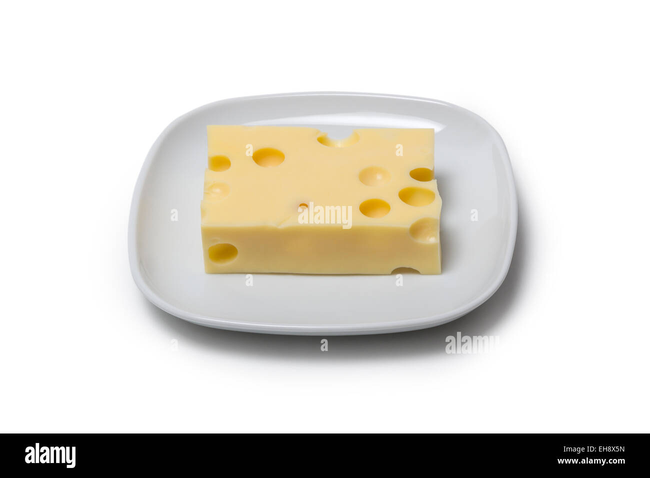Piece of Cheese on a plate isolated on white background Stock Photo
