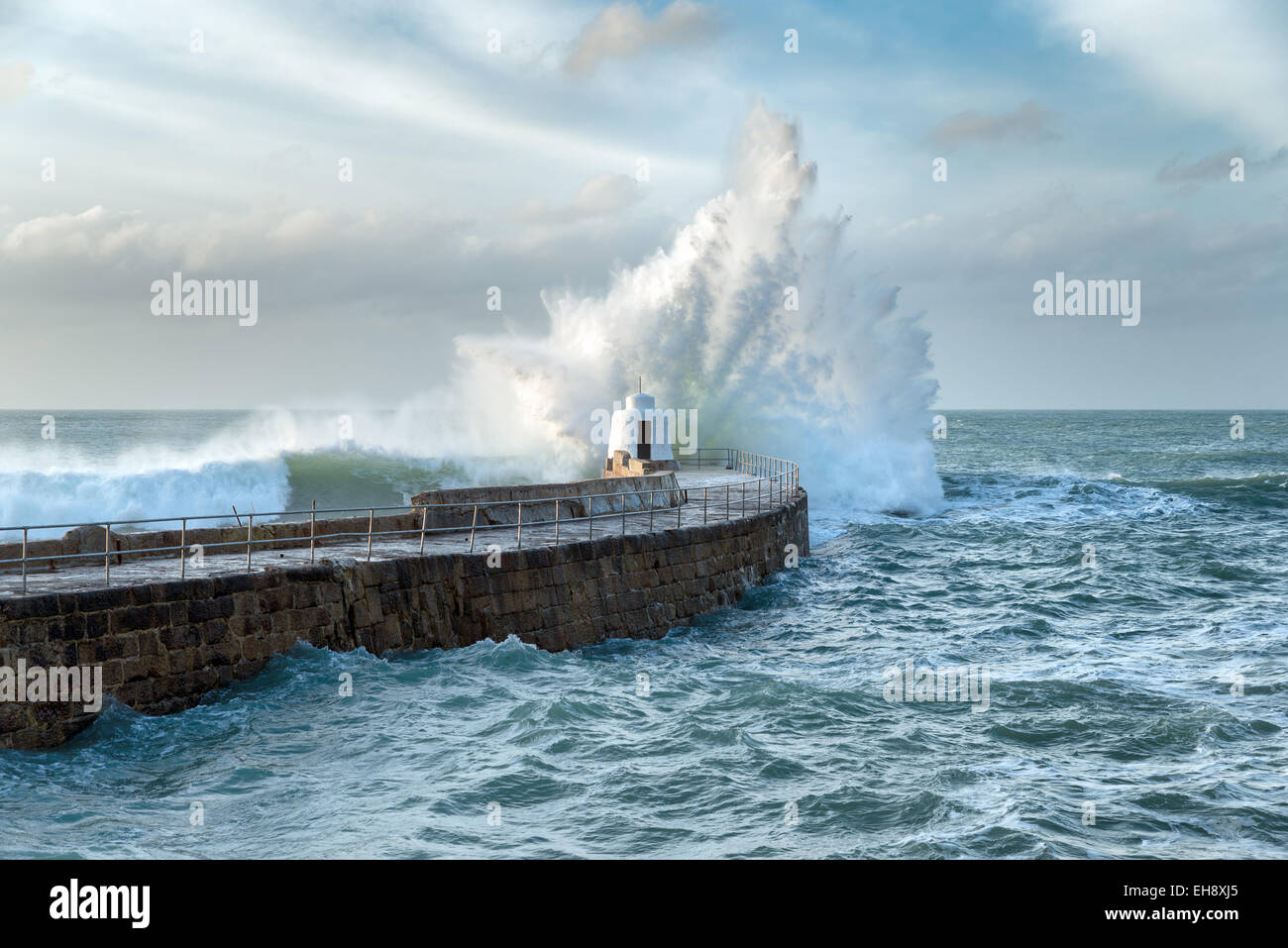 Huge waves crashing over the Monkey Hut on the stone pier at Portreath on the Cornwall coast Stock Photo