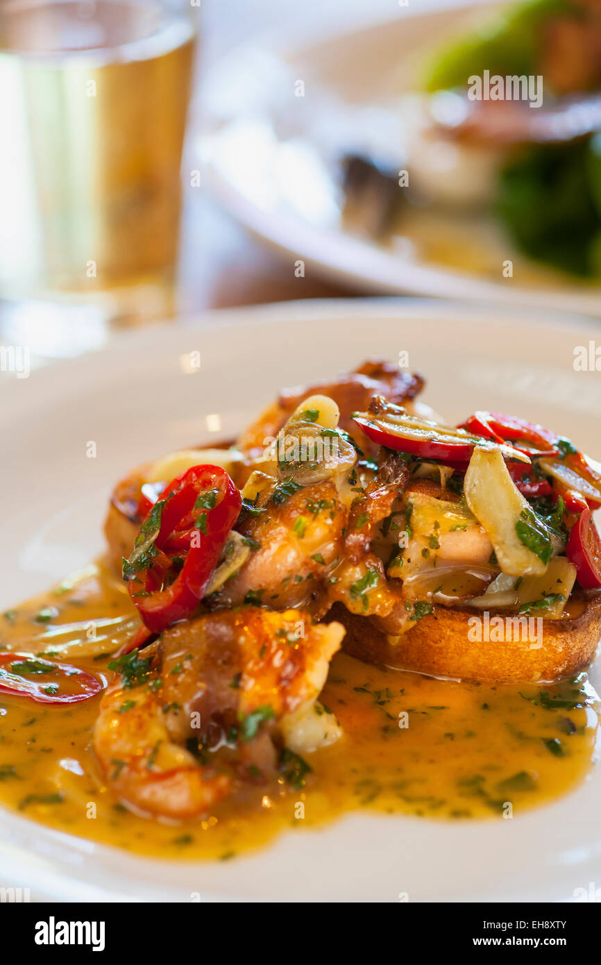 pancettawrapped white shrimp with a glass of chardonnay and a little