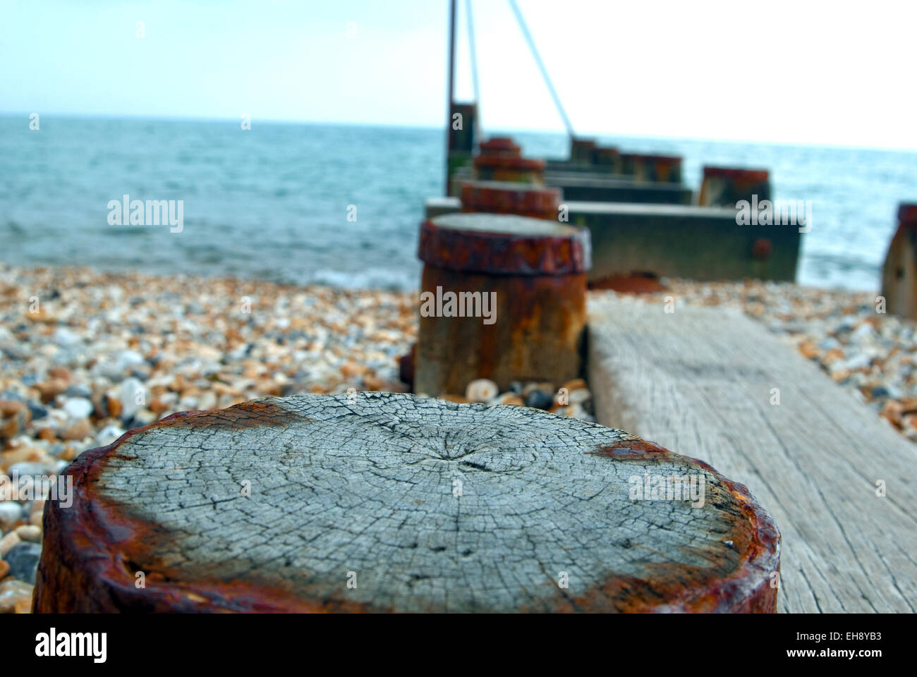 rusted sea breaker stretching from beach into the sea Stock Photo Alamy