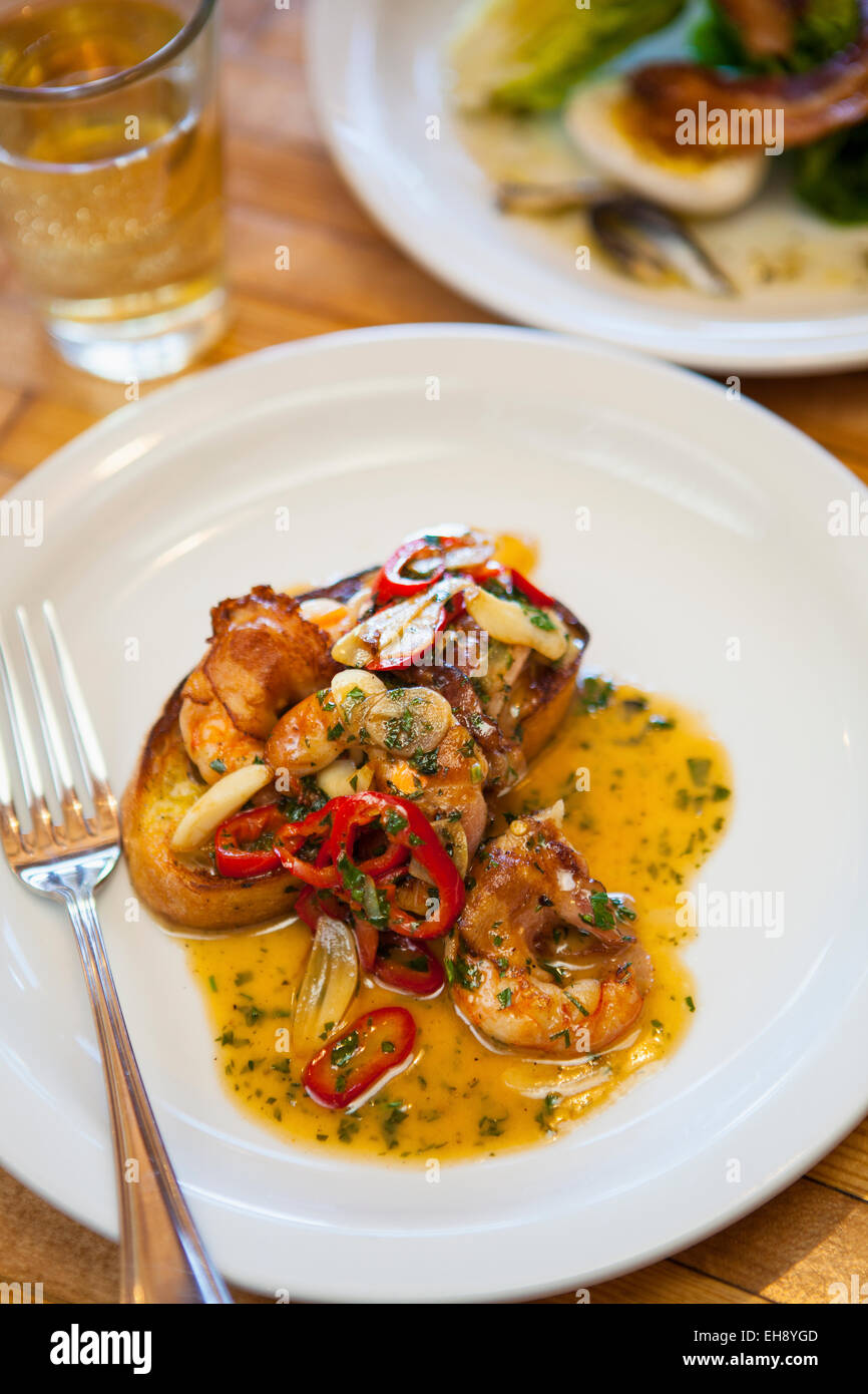 pancettawrapped white shrimp with a glass of chardonnay and a little