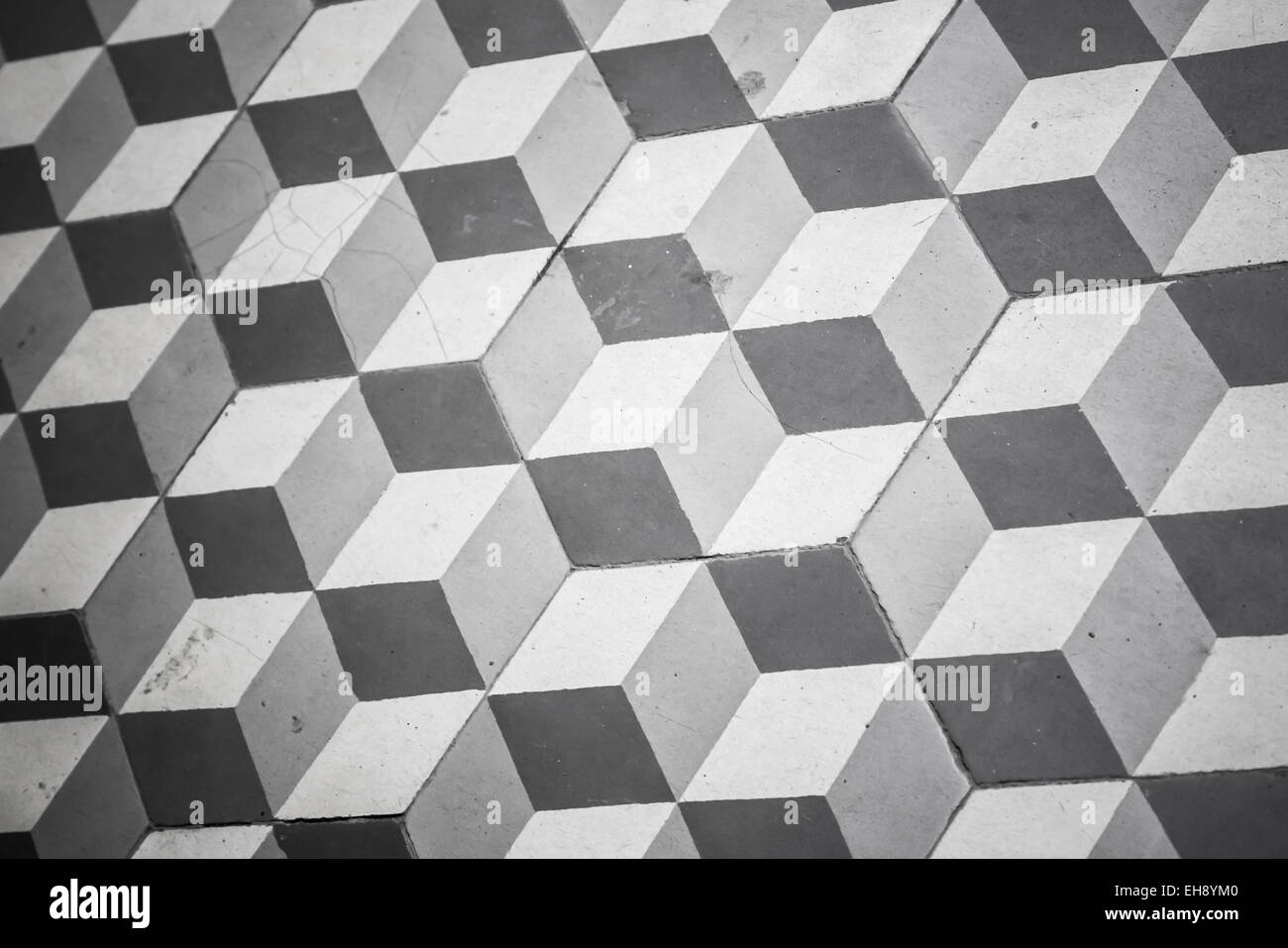 Old black and white tiling on the floor, cubic pattern Stock Photo