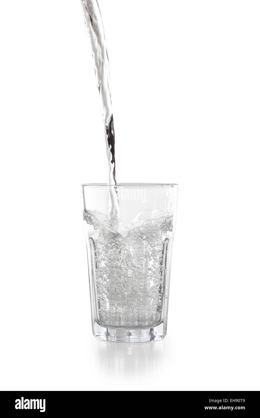 Water pouring into a glass isolated on white background Stock Photo