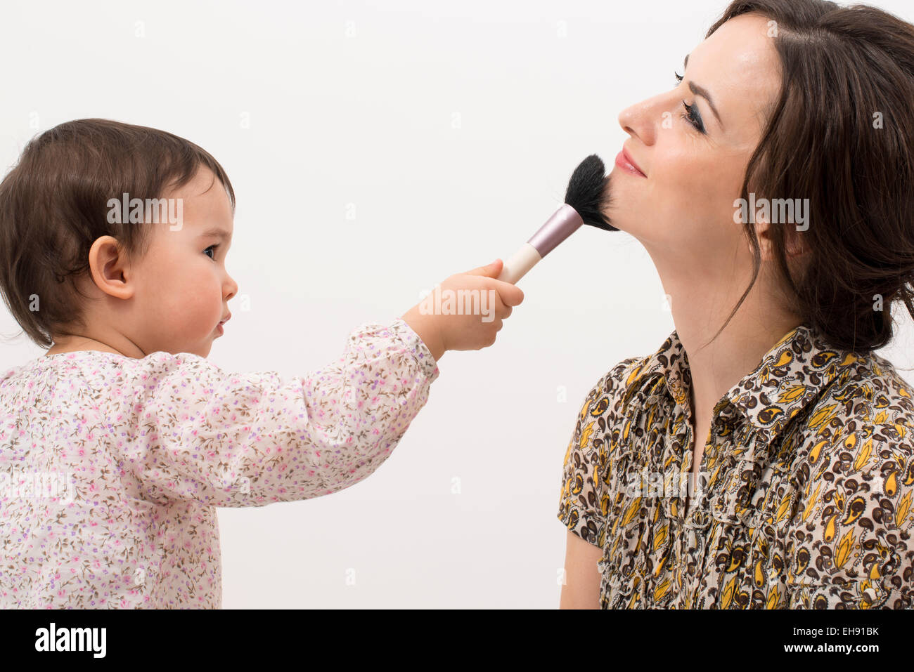 Little girl playing with her mom's makeup Stock Photo