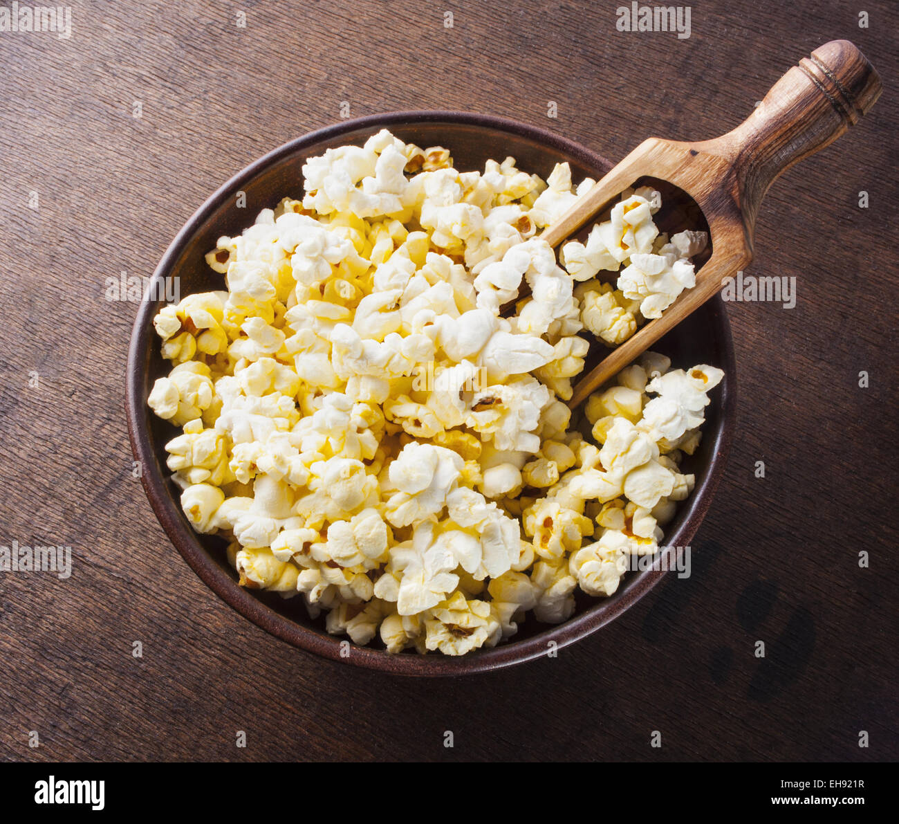 Fresh popcorn in bowl on wooden table. Stock Photo