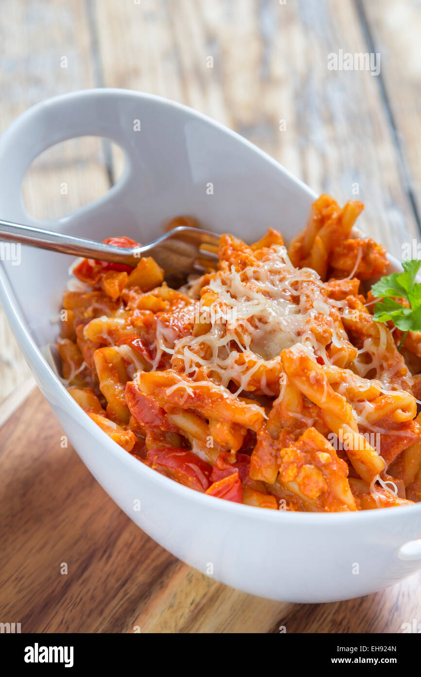 Pasta with bolognese and cheese in a modern white bowl Stock Photo