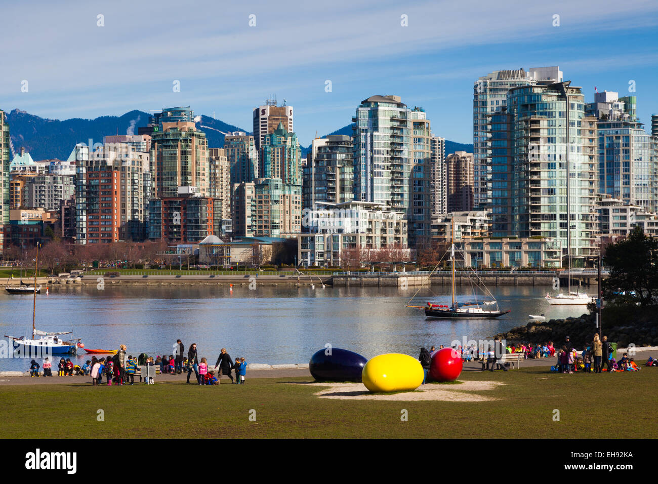 Childrens groups playing in a park by False Creek in Vancouver Stock Photo