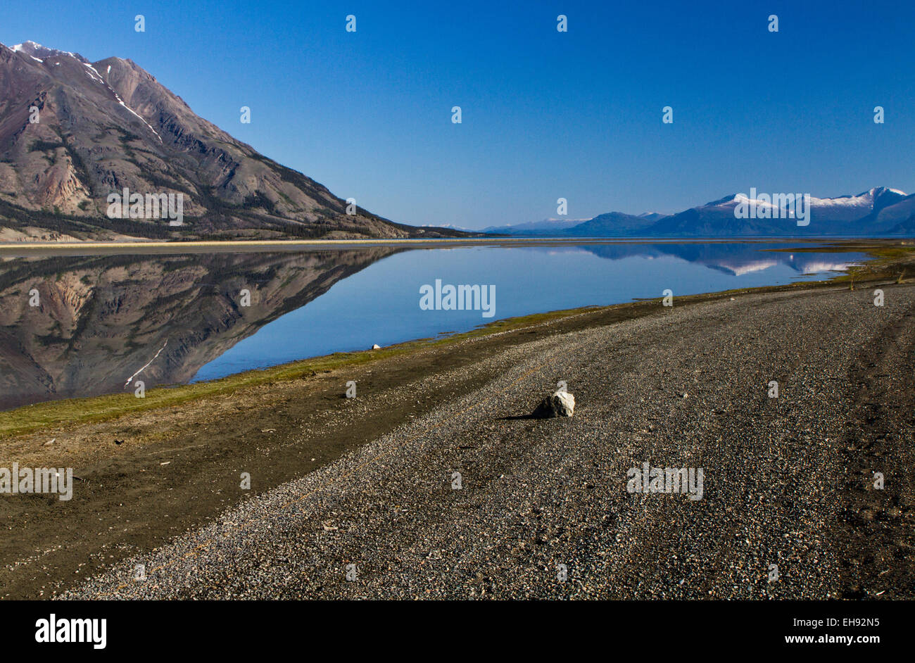 Tachal Dhal (Sheep Mountain) reflecting in Kluane Lake with the Ruby Range in the distance, Yukon Territory, Canada Stock Photo