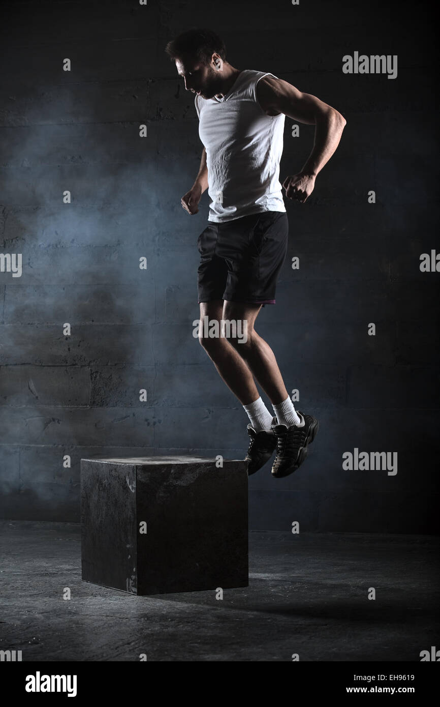 Athlete gave exercise. Jumping on the box. Phase touchdown. Stud Stock Photo