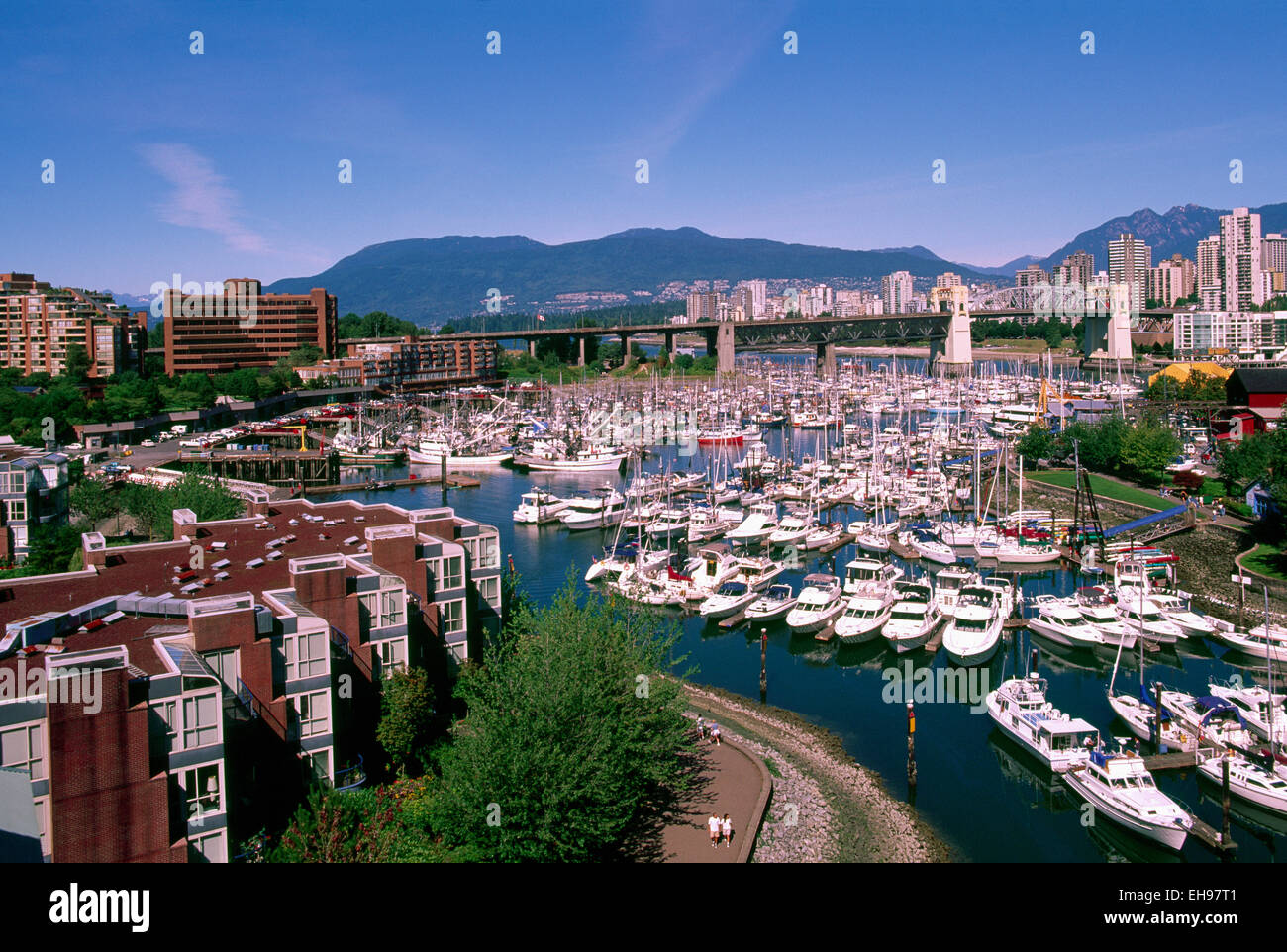 False Creek, Vancouver, BC, British Columbia, Canada - Marina at Granville Island - West End and North Shore Mountains beyond Stock Photo