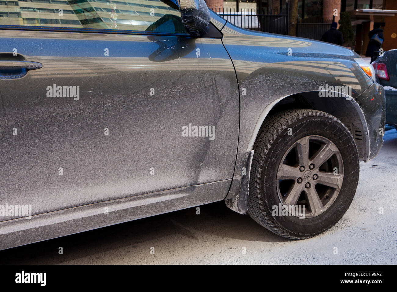Car covered in dried road salt brine - USA Stock Photo