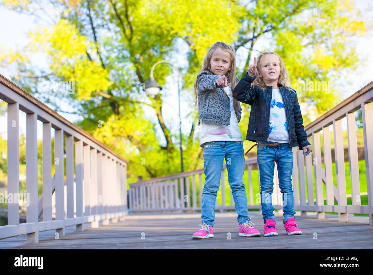 Adorable little girls at warm autumn day outdoors Stock Photo - Alamy