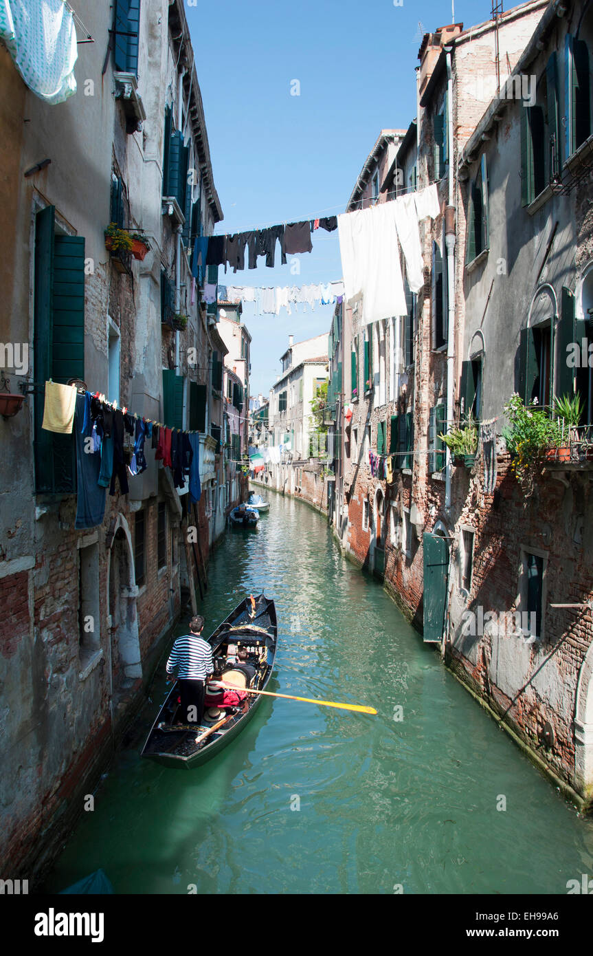 traditional canal in Venice with gondola - Italy Stock Photo