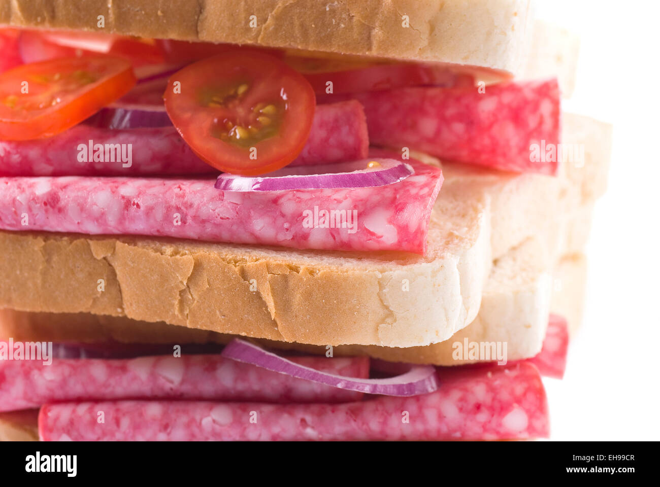 Salami sandwich with onion and tomato. Stock Photo