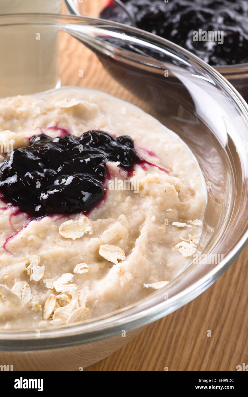 Oatmeal porridge with blueberry preserves. Stock Photo