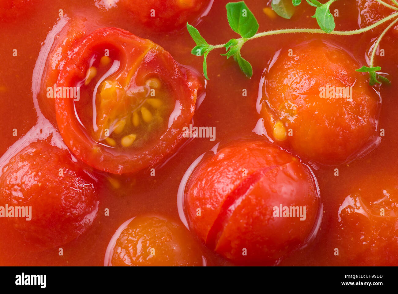 Peeled preserved tomatoes full frame. Stock Photo