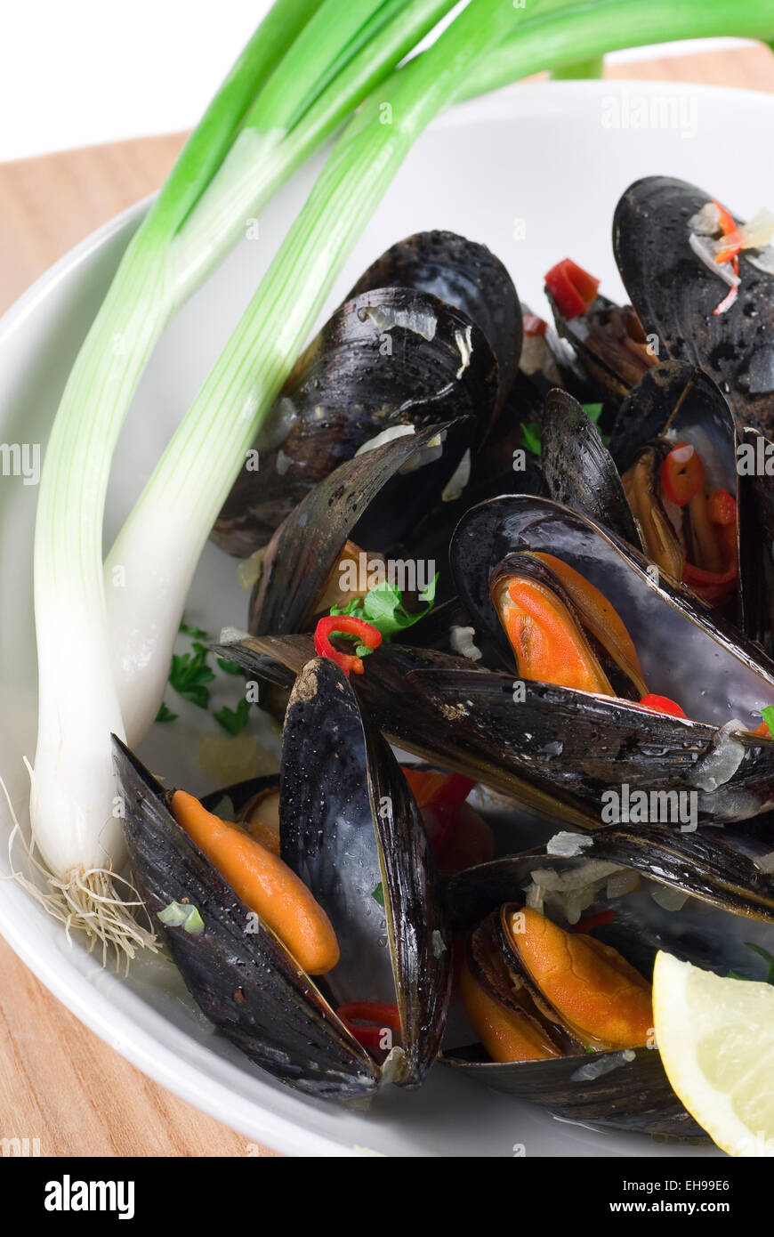 Prepared mussels with onion, chili pepper and parsley. Stock Photo