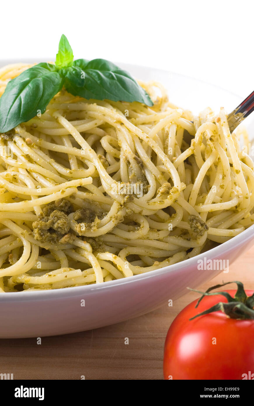 Spaghetti with green pesto in a bowl. Stock Photo