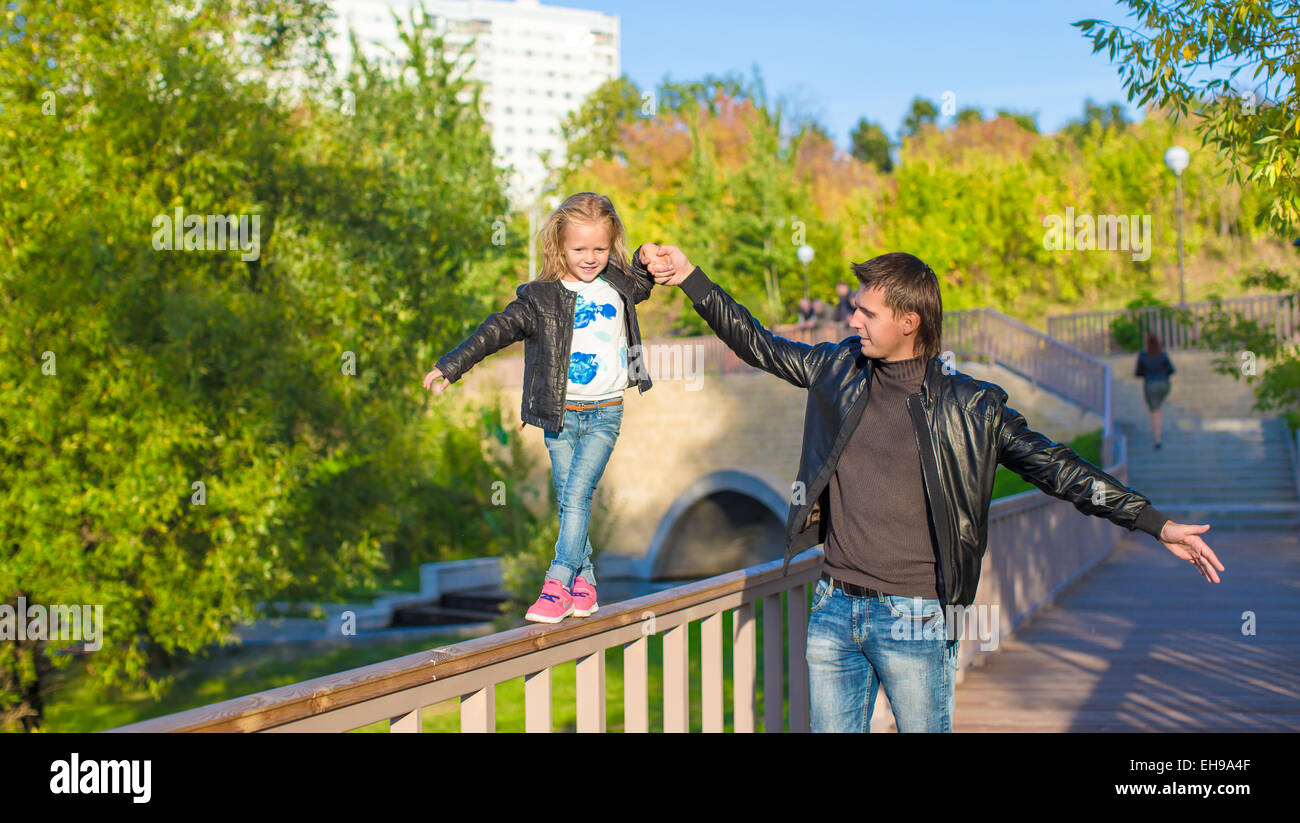Adorable daughter and little father in autumn park outdoors Stock Photo ...