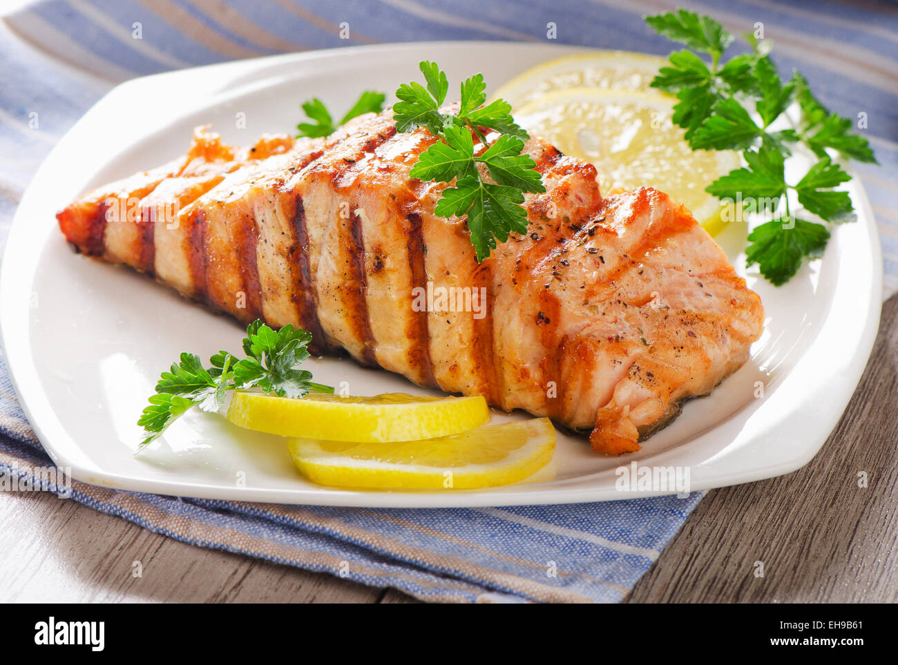 Grilled Salmon with   fresh herbs . Selective focus Stock Photo