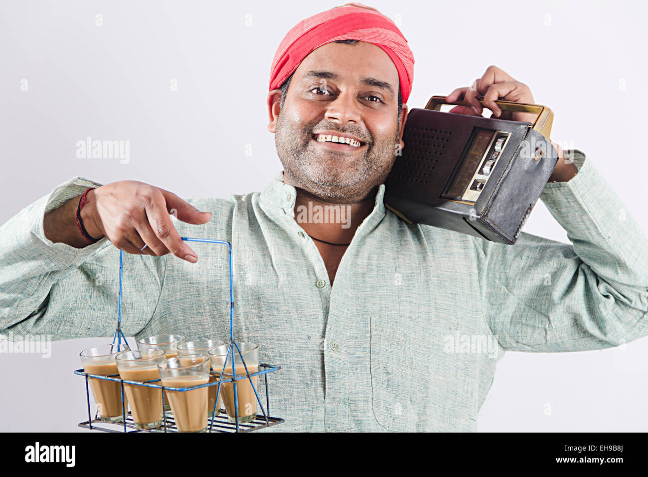 1 indian man Tea Servant hearing FM Radio Stock Photo - Alamy