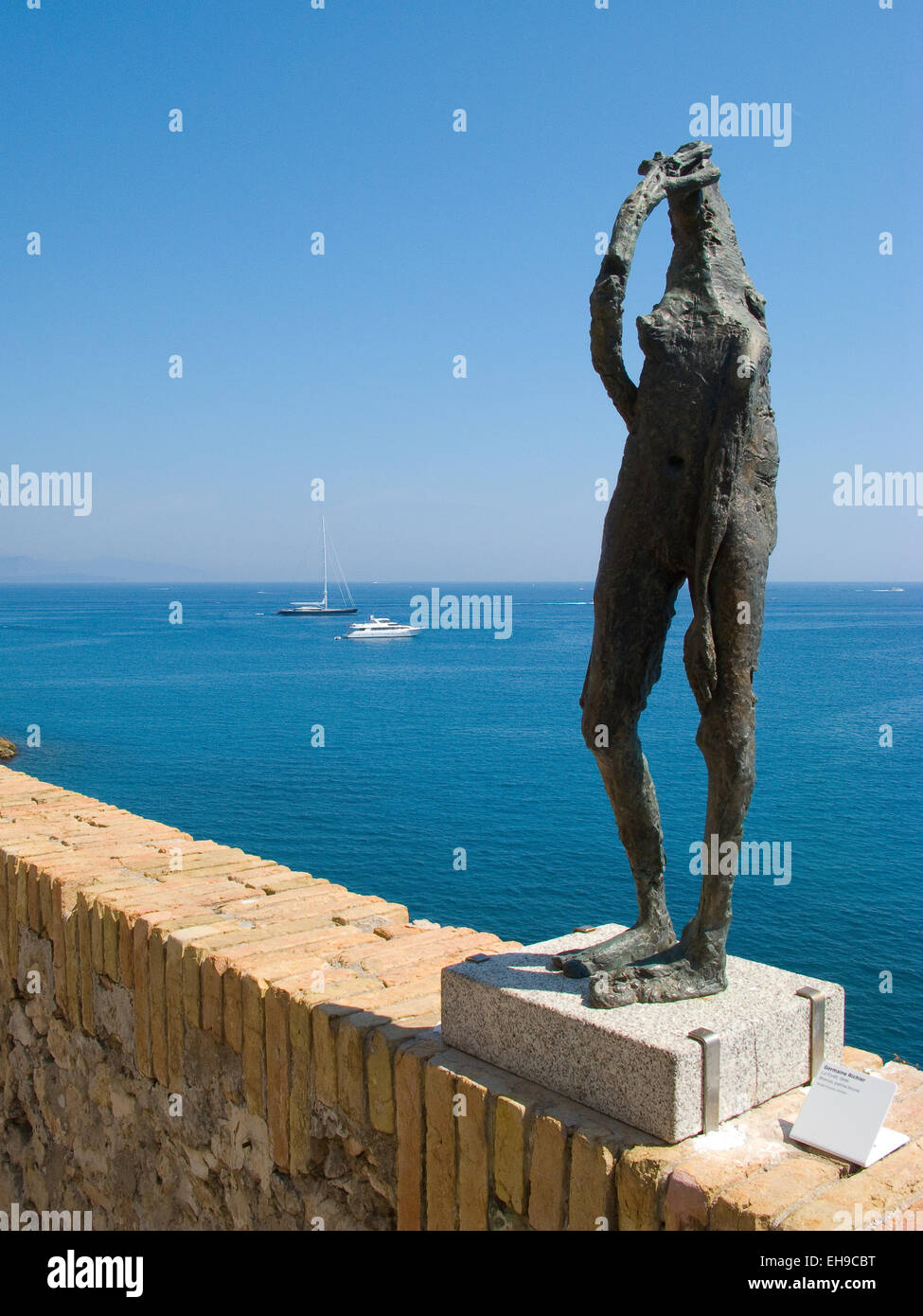 Bronze sculpture on the wall facing the sea Stock Photo