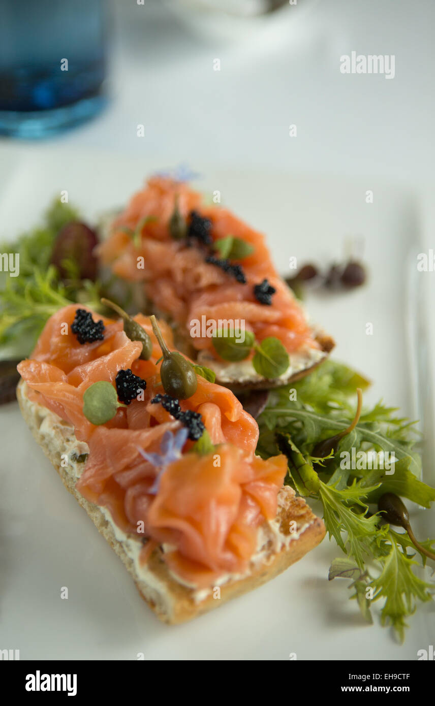 Smoked salmon with caviar and caper berries served on focaccia bread Stock Photo Alamy