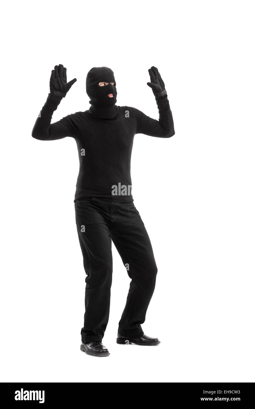 Full length portrait of a thief surrendering to someone isolated on white background Stock Photo
