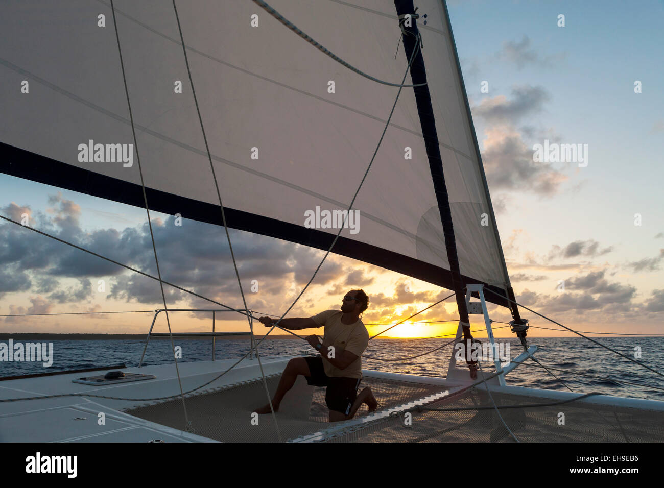 Skipper checking the tension of the sails, Grande Terre, Guadeloupe Stock Photo