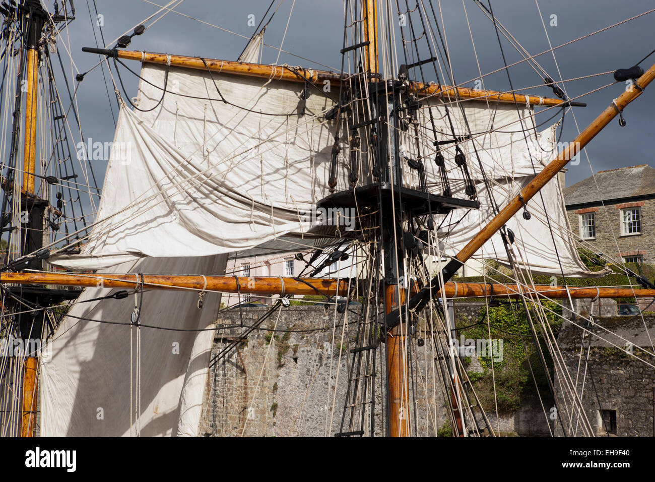 A tall ship in harbour Charlestown in Cornwall which has been used as many films and the television  series Poldark Stock Photo