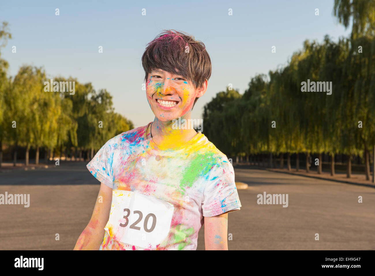 Young man at The Color Run Stock Photo - Alamy