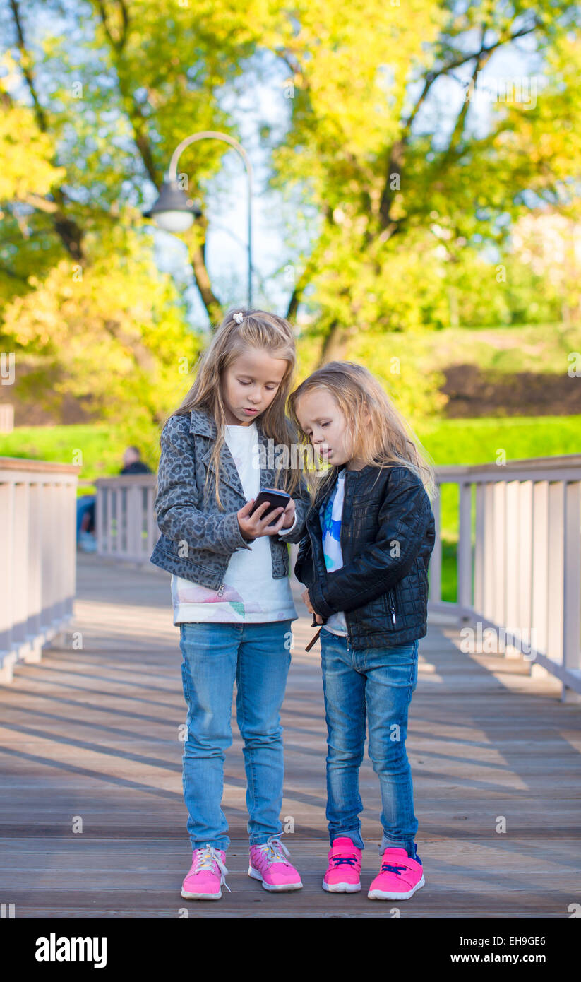 Adorable little girls at warm autumn day outdoors Stock Photo - Alamy