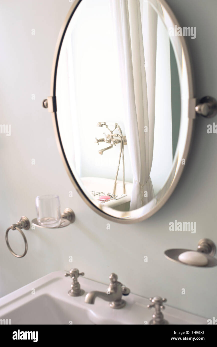 Mirror above bathroom sink Stock Photo