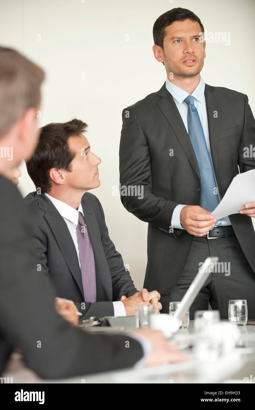 Businessman giving presentation at meeting Stock Photo