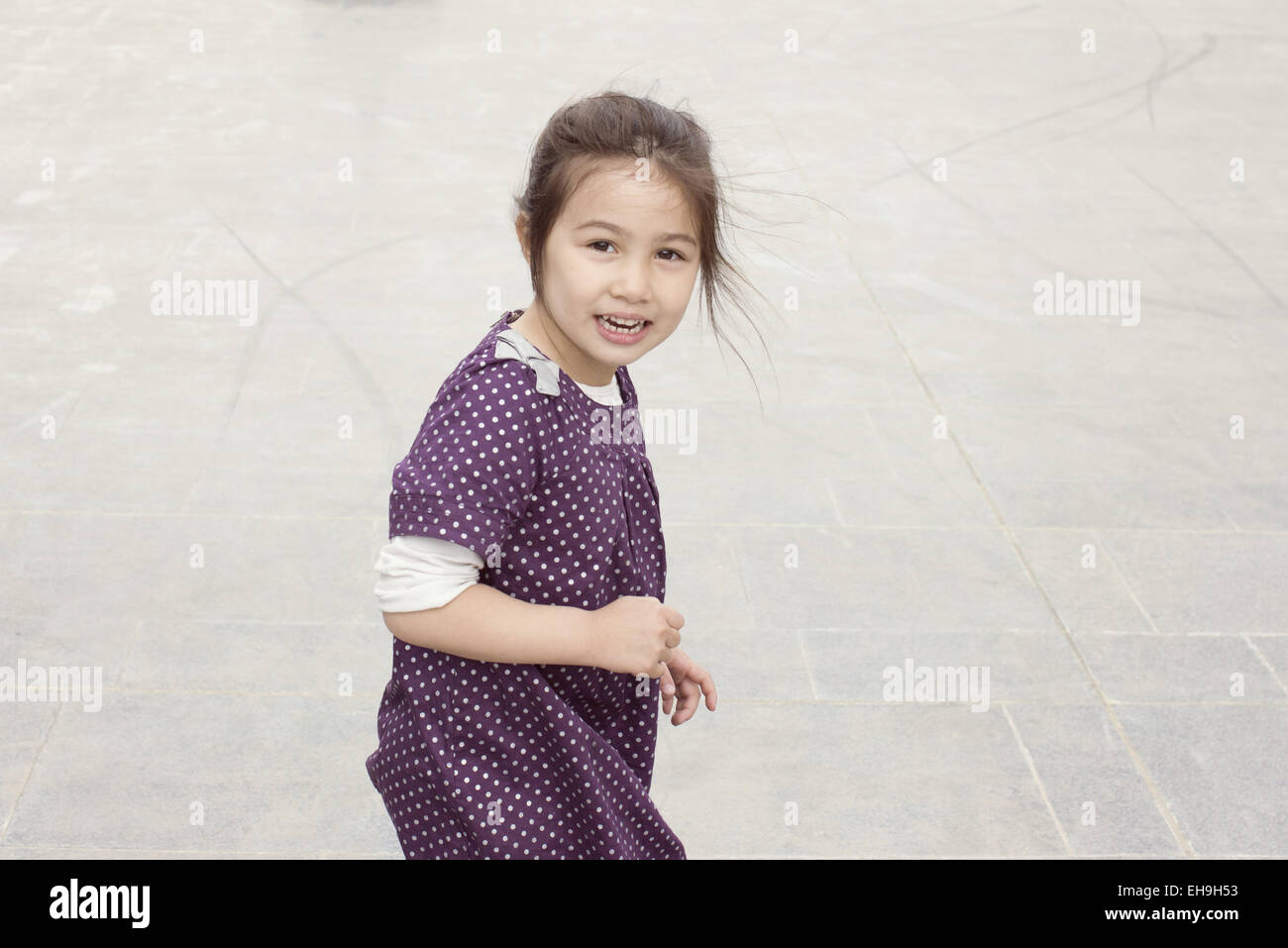 Little girl smiling outdoors Stock Photo