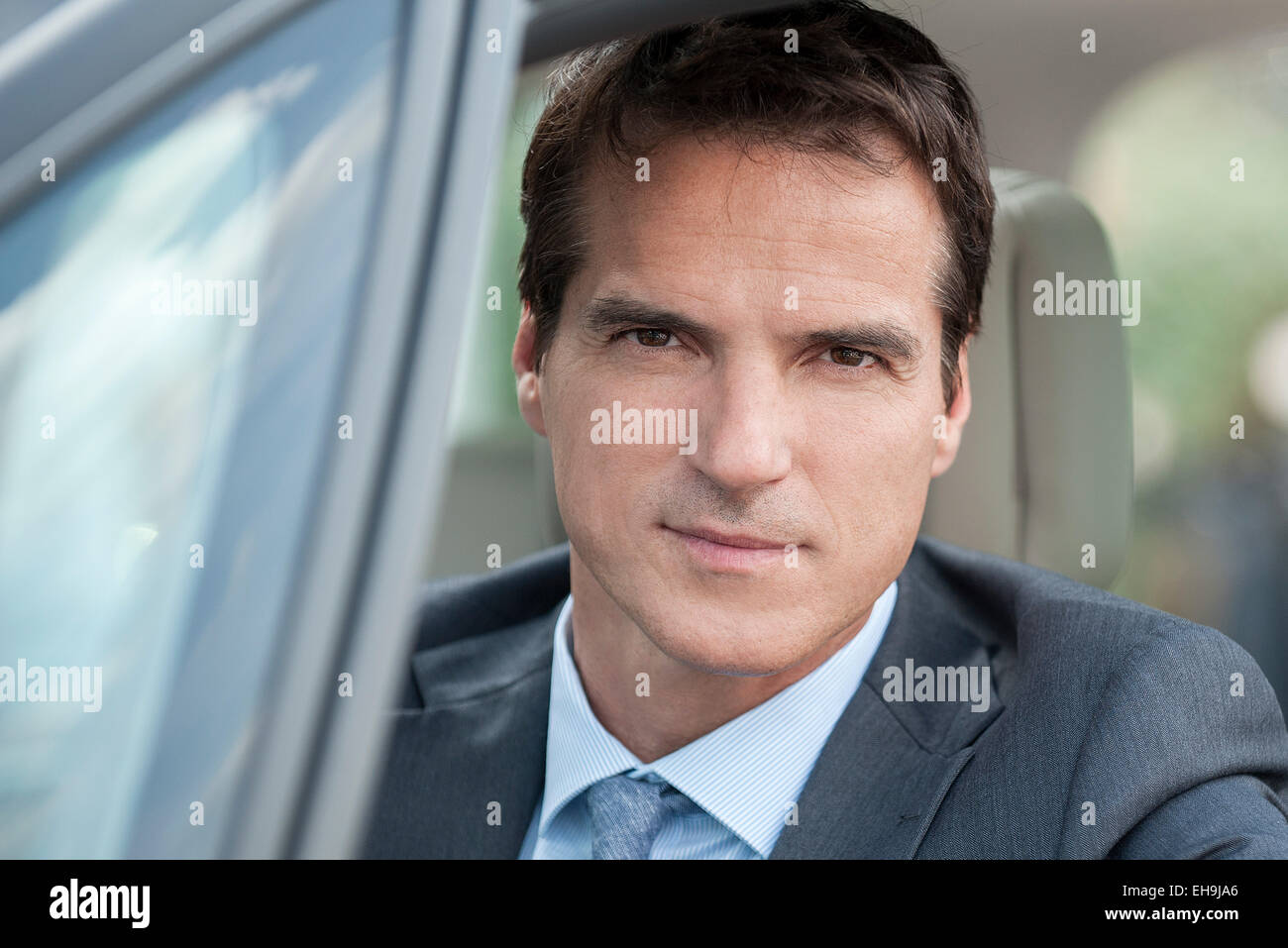 Businessman driving car, portrait Stock Photo