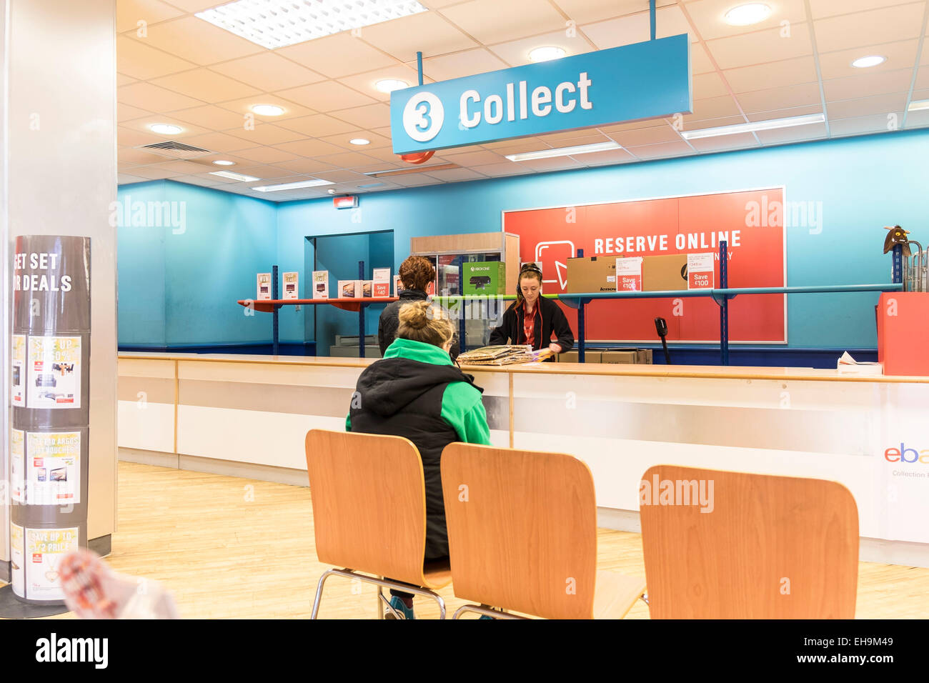 A customer waiting at the collection point inside an Argos store. Stock Photo