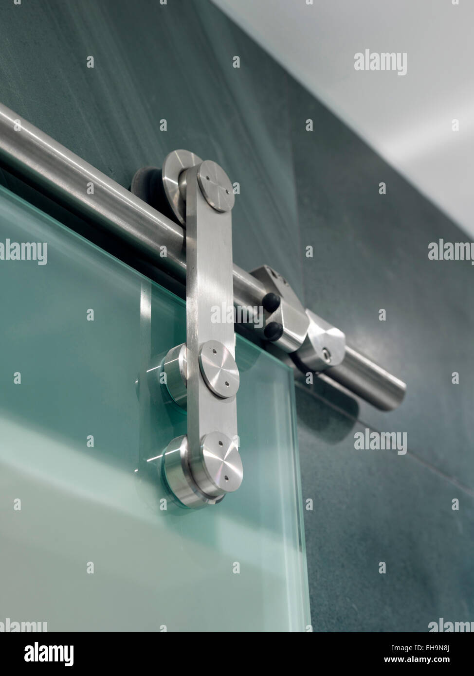 Close up of metal fixture of glass sliding door in bathroom of ... Close up of metal fixture of glass sliding door in bathroom of ...