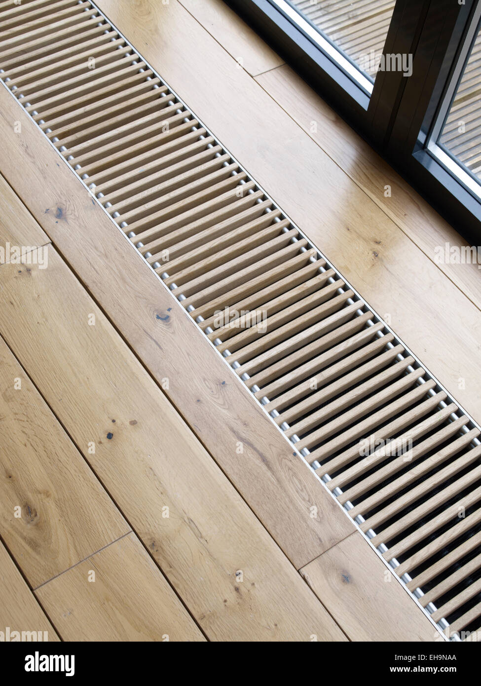 Wooden floor with air vent detail at Radinden Manor Road home, UK Stock Photo