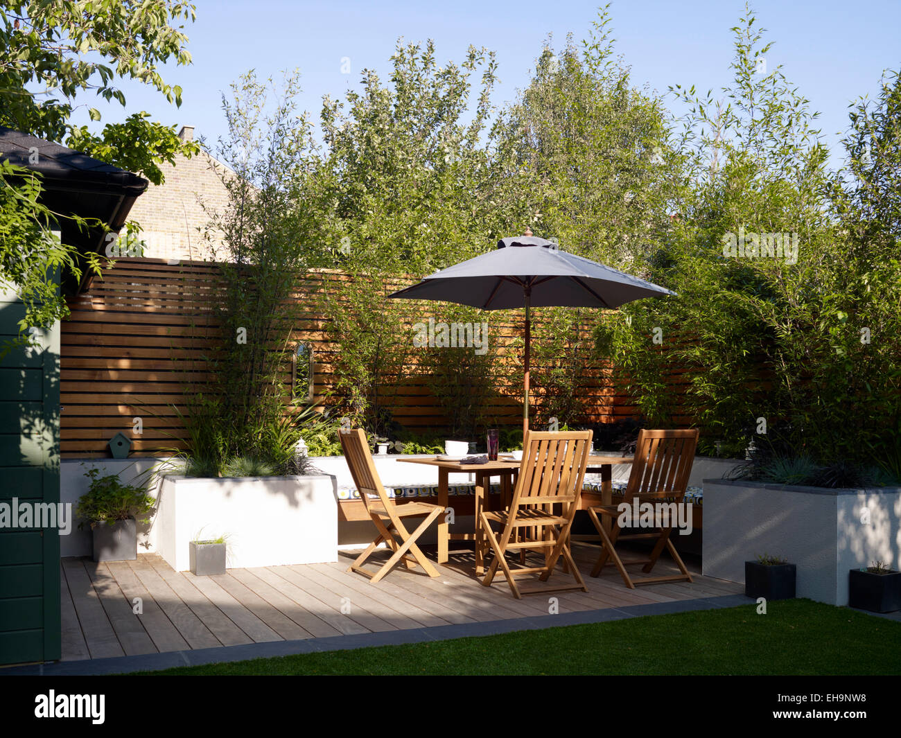 Decking with umbrella, wooden table and chairs in Ellerby Street home