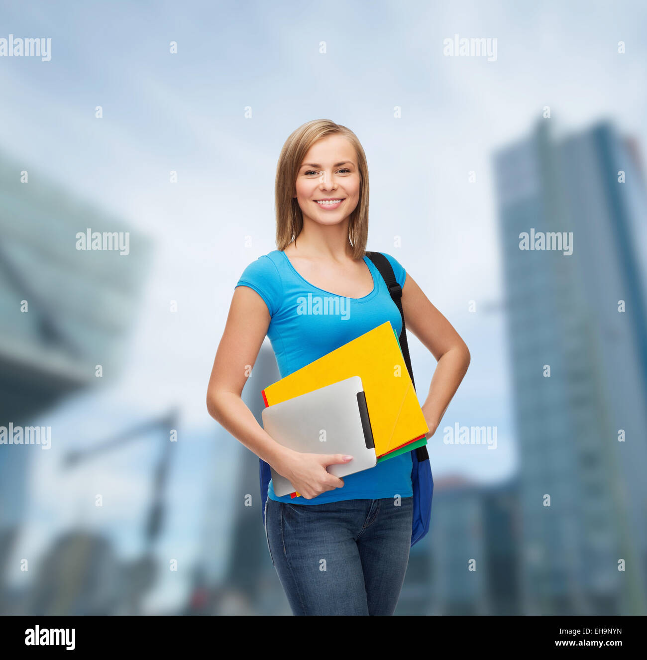 smiling student with bag, folders and tablet pc Stock Photo - Alamy