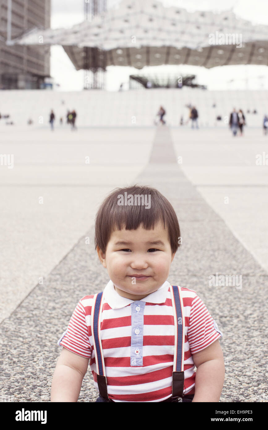 Baby boy in city square, portrait Stock Photo